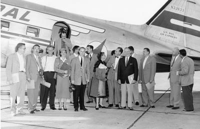 People standing around an airplane.